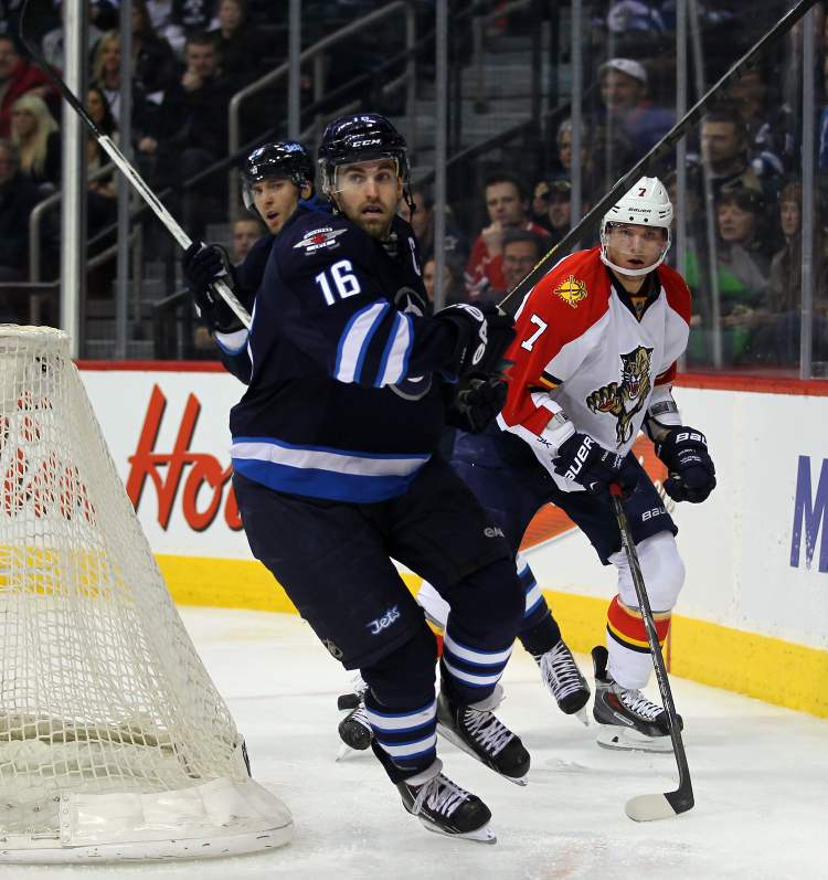 Phil Hossack / Winnipeg Free Press
Winnipeg Jets captain Andrew Ladd wheels around Dmitry Kulikov behind the Florida Panthers net in the second period Thursday. S