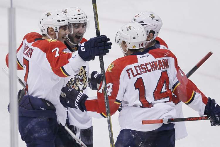 JOHN WOODS / THE CANADIAN PRESS
Florida Panthers Dmitry Kulikov (7), TJ Brennan (3), Tomas Fleischmann (14) and Marcel Goc (57) celebrate Fleischmann's goal against the Winnipeg Jets during first-period NHL action in Winnipeg Thursday.