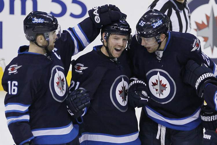 JOHN WOODS / THE CANADIAN PRESS
Winnipeg Jets Andrew Ladd (16), Aaron Gagnon (21) and Blake Wheeler (26) celebrate Gagnon's goal against the Florida Panthers during the first period in Winnipeg Thursday.