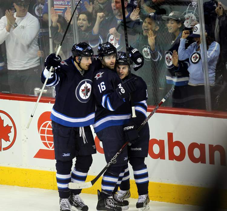 Phil Hossack / Winnipeg Free Press
Winnipeg Jets forward Blake Wheeler, captain Andrew Ladd and Bryan Little celebrates Ladd's goal Thursday.