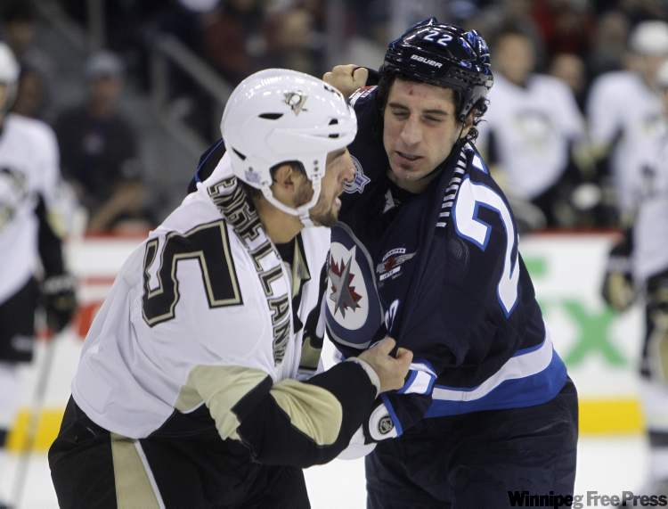 Deryk Engelland of the Pittsburgh Penguins and Chris Thorburn of the Winnipeg Jets fight during the first period. (Trevor Hagan / Winnipeg Free Press)