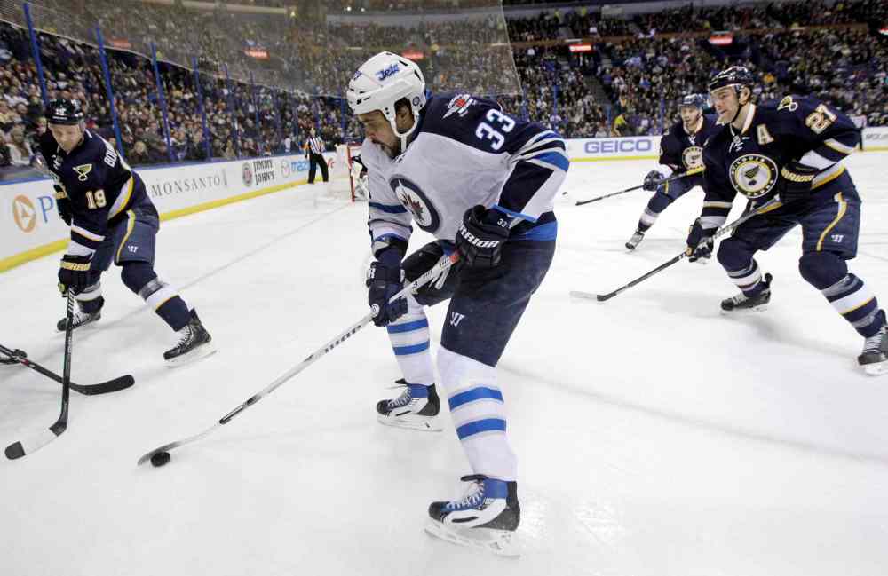 Jeff Roberson / The Associated Press
Winnipeg Jets' Dustin Byfuglien (33) controls the puck as St. Louis Blues' Jay Bouwmeester (19), Maxim Lapierre (40) and Alex Pietrangelo (27) defend during the first period.