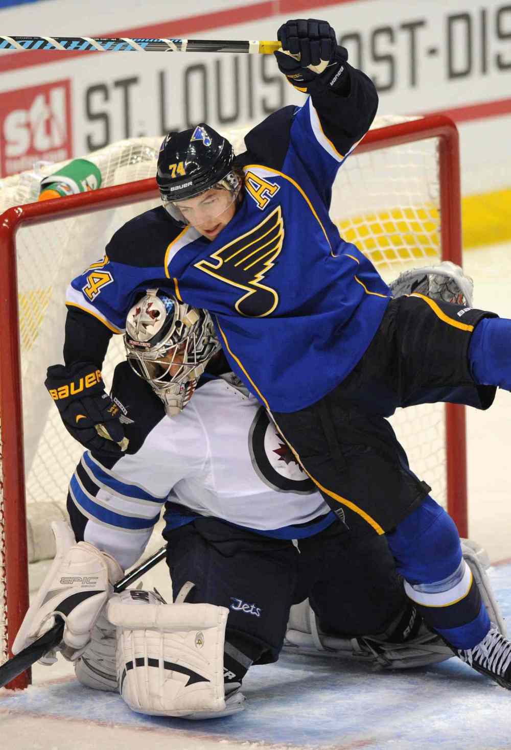 Bill Boyce / the associated press
St. Louis Blues' T.J. Oshie falls over Winnipeg Jets goalie Ondrej Pavelec during the third period.