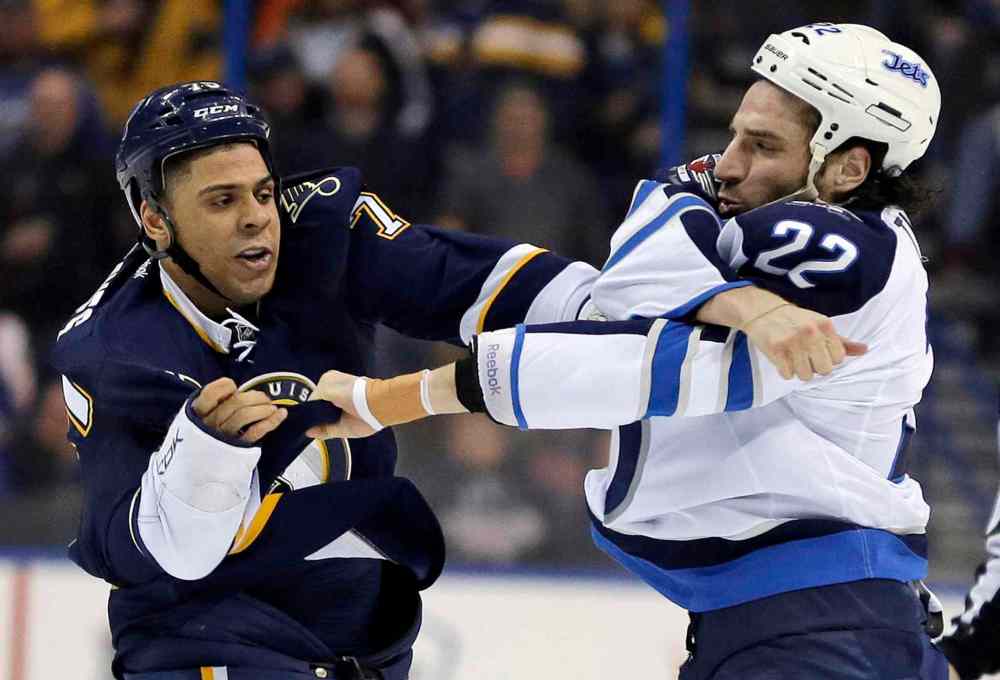 Jeff Roberson / The Associated Press
St. Louis Blues' Ryan Reaves, left, and Winnipeg Jets' Chris Thorburn have a first-period fight.