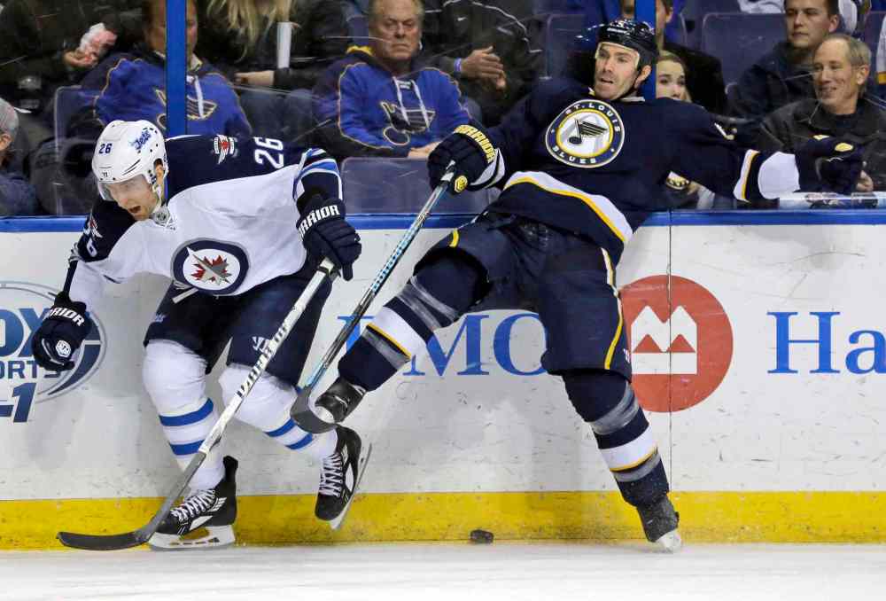 Jeff Roberson / The Associated Press
Winnipeg Jets' Blake Wheeler, left, and St. Louis Blues' Barret Jackman collide along the boards while chasing a loose puck during the first period.