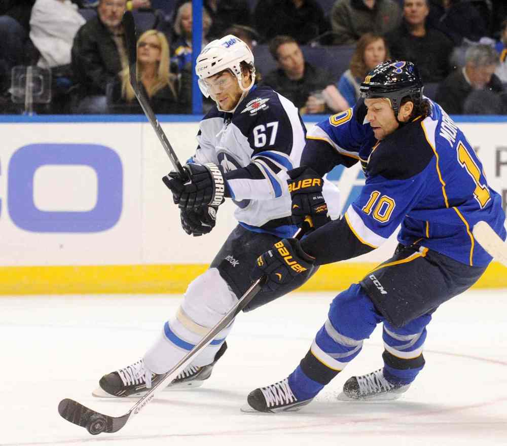Bill Boyce / the associated press
St. Louis Blues' Brenden Morrow and Winnipeg Jets' Michael Frolik battle for the puck during the first period.