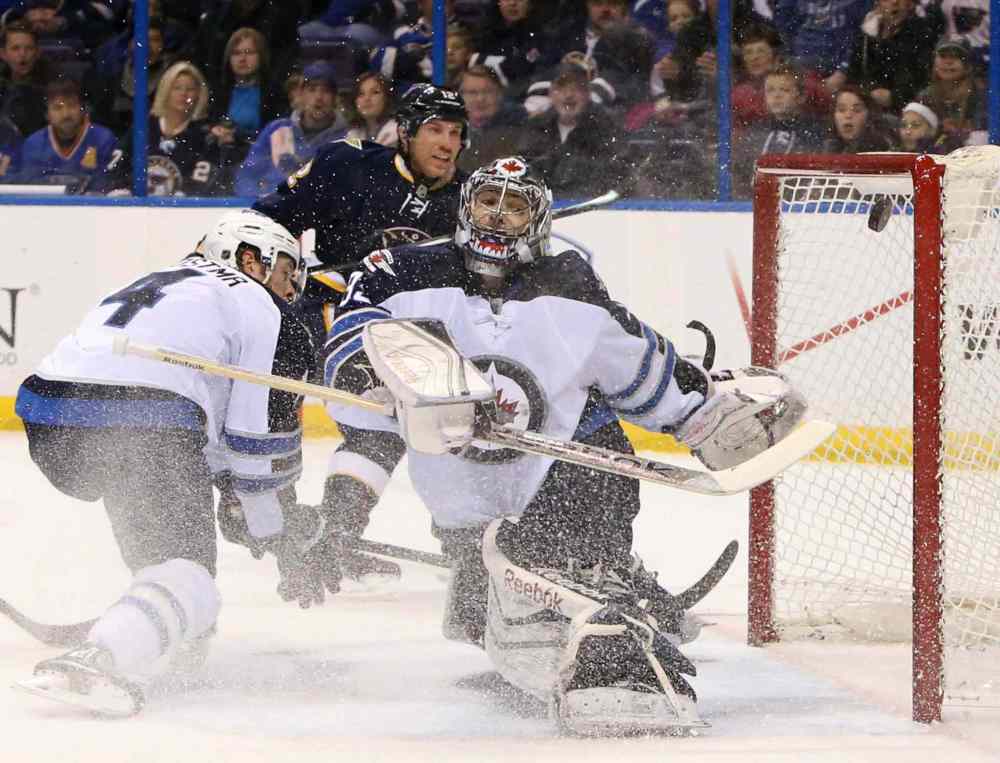 Chris Lee/St. Louis Post-Dispatch/MCT
Derk Roy, back, scores against Winnipeg Jets' goalie Al Montoya on Saturday in St. Louis.