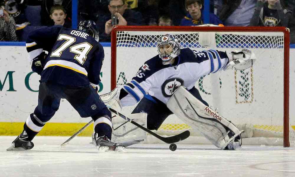 Jeff Roberson / The Associated Press
St. Louis Blues' T.J. Oshie, left, scores against Winnipeg Jets' goalie Al Montoya. The Blues won 4-3 in a shootout.