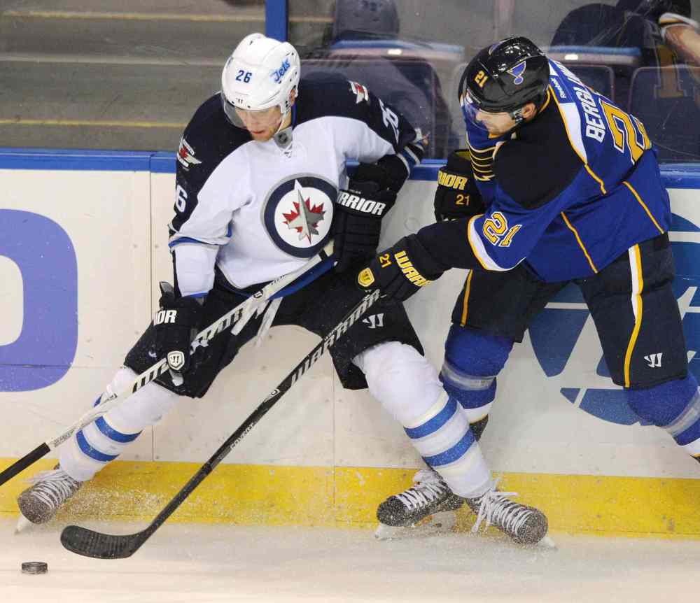 Bill Boyce / the associated press
St. Louis Blues' Patrik Berglund and Winnipeg Jets' Blake Wheeler battle for the puck during the second period.