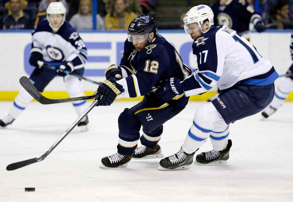Jeff Roberson / The Associated Press
St. Louis Blues' Derek Roy, left, and Winnipeg Jets' James Wright chase after a loose puck during the second period of Saturday's game.