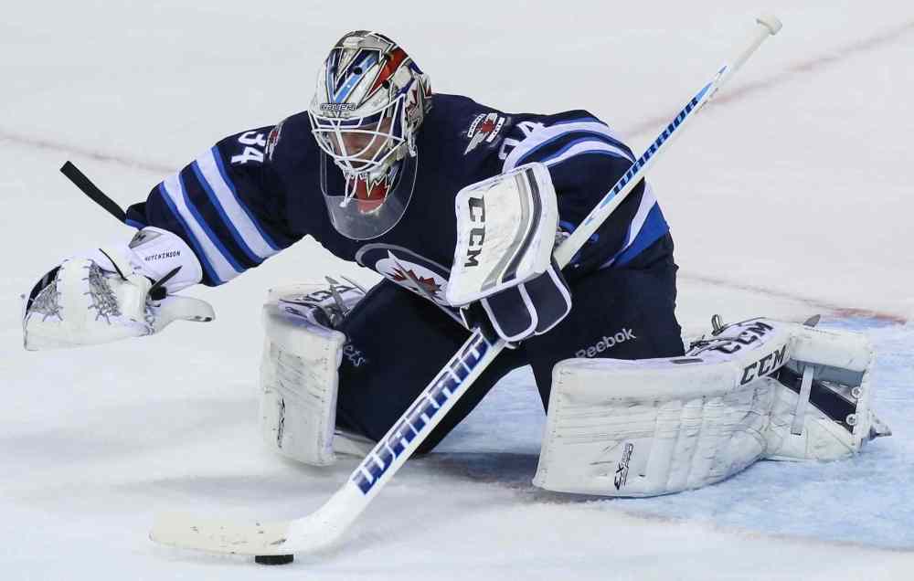 Crystal Schick/Winnipeg Free Press
Winnipeg Jets' goaltender Michael Hutchinson jumps on this puck and stops all second-period shots from the Boston Bruins. The score remained 1 to 0 for the Bruins after two.