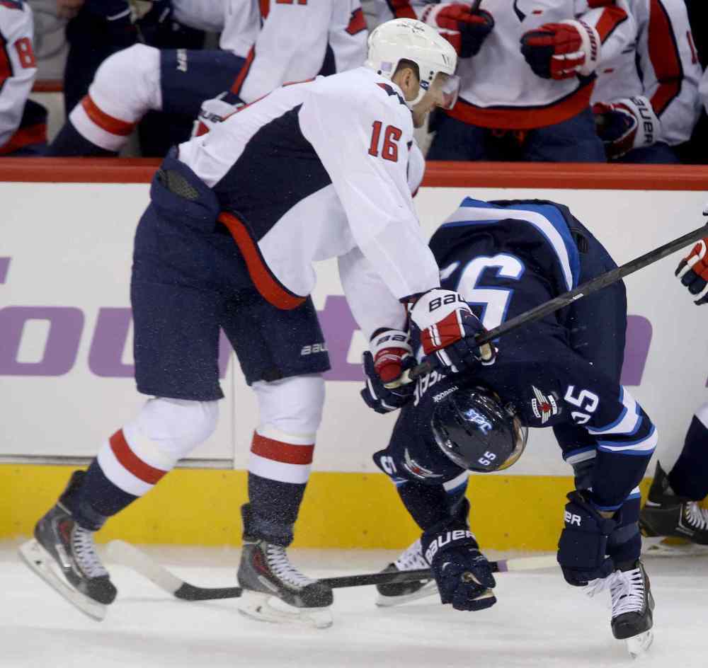 CP
Washington Capitals forward Eric Fehr lays the lumber on Winnipeg Jets forward Mark Scheifele in front of the Capitals bench during the first period.