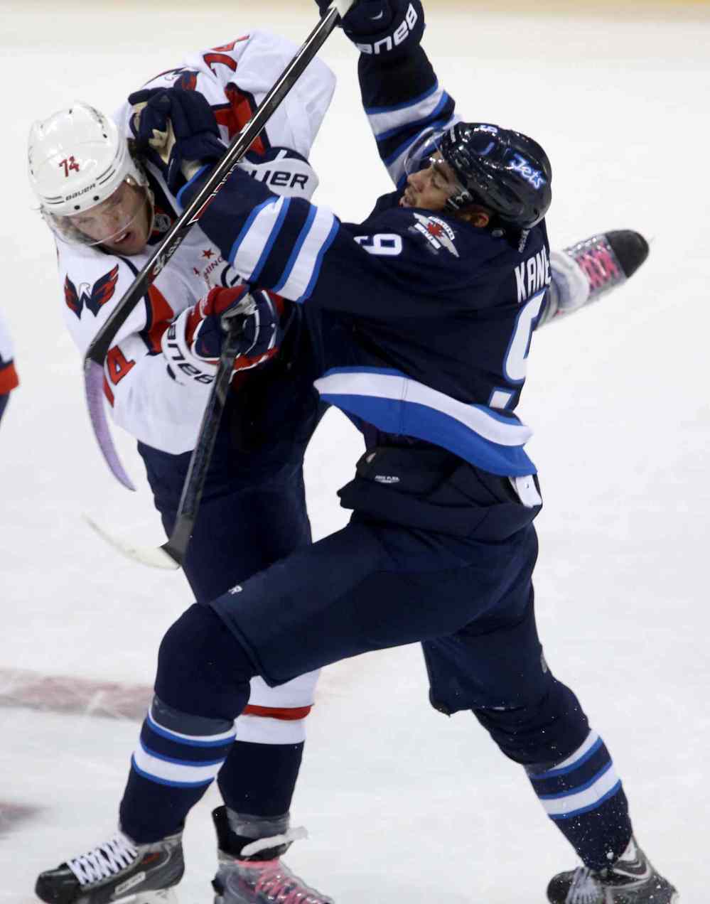 TREVOR HAGAN / THE CANADIAN PRESS
Winnipeg Jets forward Evander Kane collides with Washington Capitals' John Carlson during the first period.