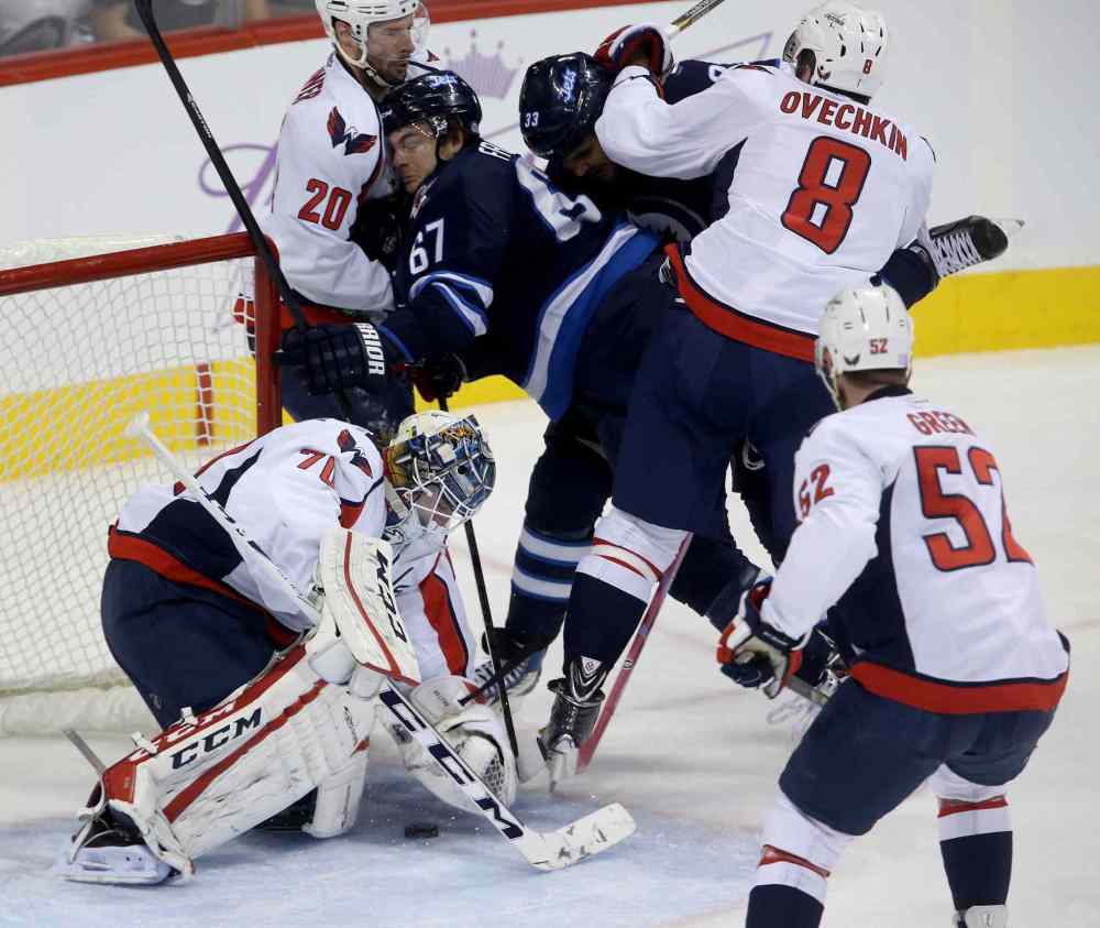 TREVOR HAGAN / THE CANADIAN PRESS
Winnipeg Jets players Michael Frolik (67) and Dustin Byfuglien are sandwiched between Washington Capitals players Troy Brouwer (20) and Alex Ovechkin in front of goaltender Braden Holtby during the first period.