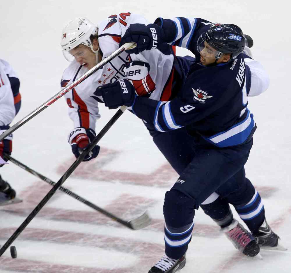 TREVOR HAGAN / THE CANADIAN PRESS
Winnipeg Jets forward Evander Kane mixes it up with Washington Capitals' John Carlson.