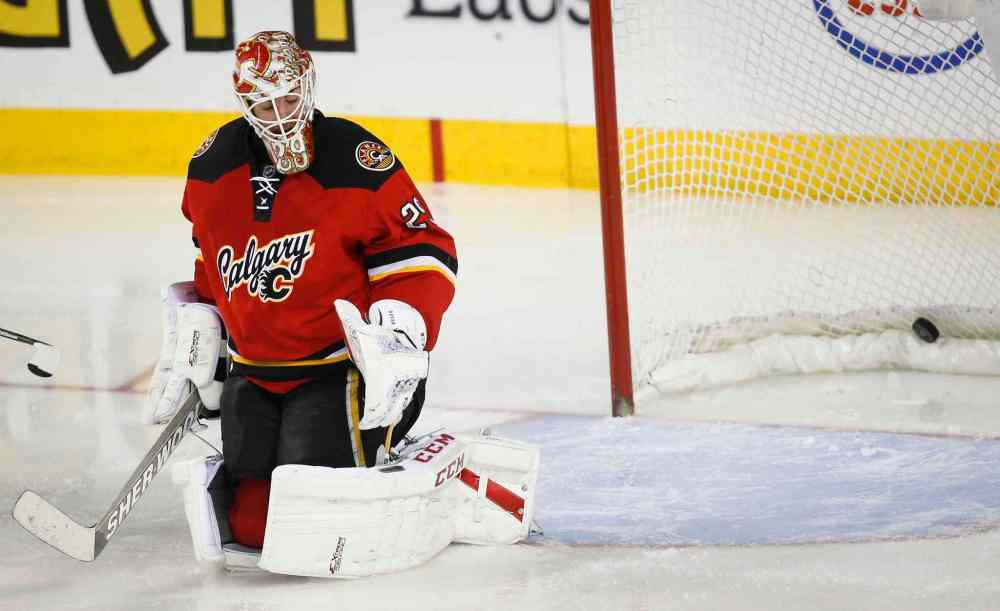 Jeff McIntosh / The Canadian Press
Calgary Flames' goalie Reto Berra reacts after letting in the fifth goal during third period against the Winnipeg Jets in Calgary Thursday.