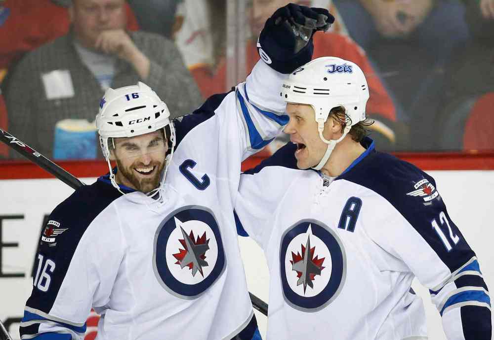 Jeff McIntosh / The Canadian Press
Winnipeg Jets' Olli Jokinen, right, celebrates his second-period goal with teammate Andrew Ladd Thursday.