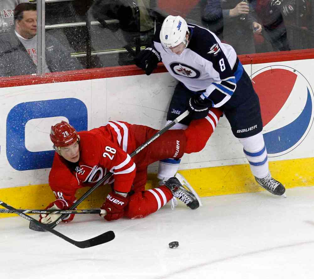 Chris Seward / Raleigh News & Observer/ Tribune Media MCT
Carolina Hurricanes' Alexander Semin (28) battles Winnipeg Jets' Jacob Trouba (8) for the puck during second period at the PNC Arena in Raleigh, N.C., on Tuesday.
