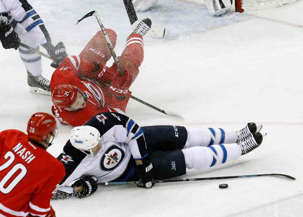 Chris Seward / Raleigh News & Observer/ Tribune Media MCT
Carolina Hurricanes' Riley Nash (20) and Drayson Bowman (21) battle Winnipeg Jets' Adam Pardy (2) for the puck during the second period of Tuesday's game.