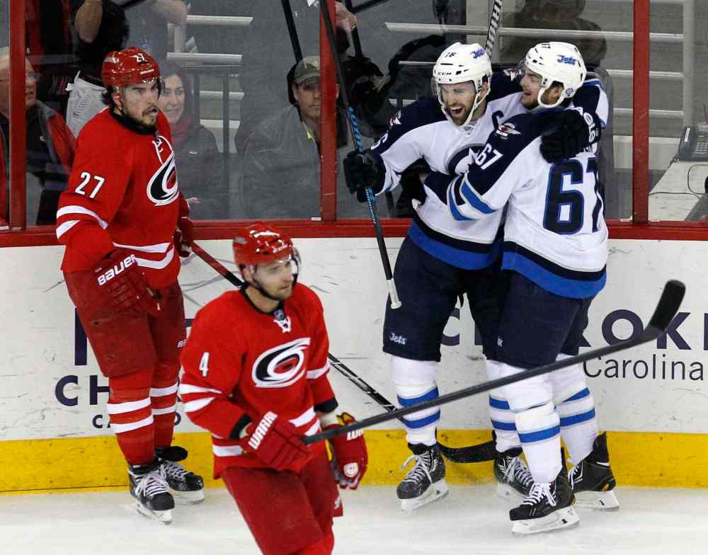 Chris Seward / Raleigh News & Observer/ Tribune Media MCT
Winnipeg Jets' Andrew Ladd (16) celebrates his second-period goal with teammate Michael Frolik (67) during Tuesday's game in Raleigh.