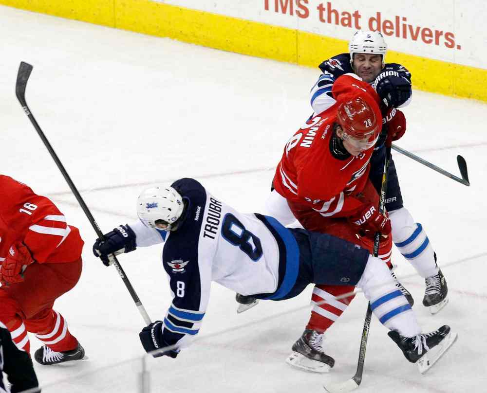 Chris Seward / Raleigh News & Observer/ Tribune Media MCT
Carolina Hurricanes' Alexander Semin (28) and Winnipeg Jets' Jacob Trouba (8) and Mark Stuart (5) collide during the second period of Tuesday's game.