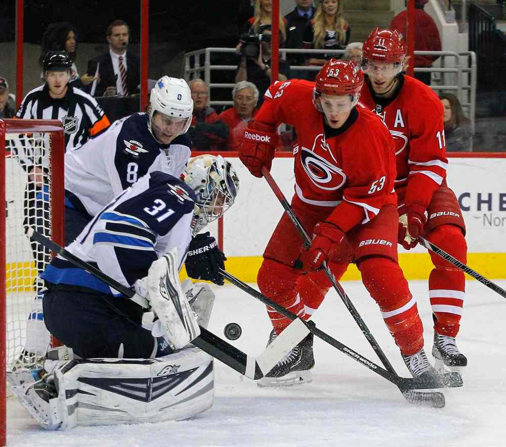 Chris Seward / Raleigh News & Observer/ Tribune Media MCT
Carolina Hurricanes' Jeff Skinner (53) and Eric Staal (12) work against Winnipeg Jets' Jacob Trouba (8) and Ondrej Pavelec (31) during the first period at the PNC Arena in Raleigh, N.C., on Tuesday, Feb. 4, 2014.