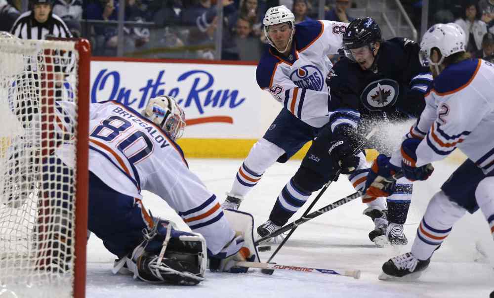 Trevor Hagan / Winnipeg Free Press
Edmonton Oilers' goaltender Ilya Bryzgalov (80) stops Winnipeg Jets' Anthony Peluso (14) as he drives between Oilers' Martin Marincin (85) and Jeff Petry (2) during the second period Saturday.