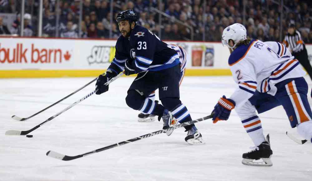 Trevor Hagan / Winnipeg Free Press
Winnipeg Jets' Dustin Byfuglien (33) drives to the net past Edmonton Oilers' Jeff Petry (2) during second period NHL hockey action at MTS Centre in Winnipeg on Saturday.
