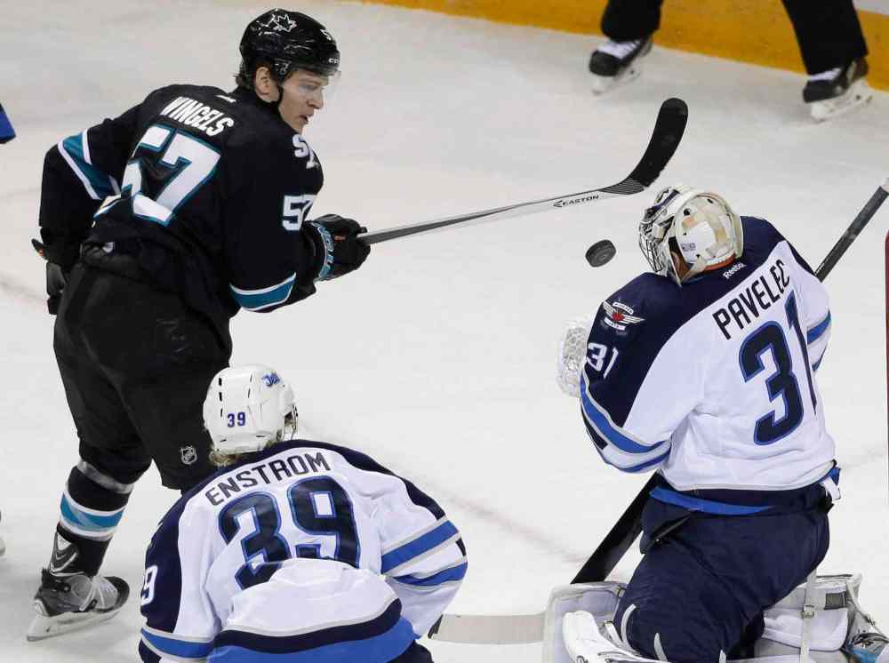 Marcio Jose Sanchez / The Associated Press
Winnipeg Jets goalie Ondrej Pavelec (31), of the Czech Republic, stops a shot by San Jose Sharks' Tommy Wingels (57) during the first period of Thursday's NHL hockey game in San Jose, Calif.