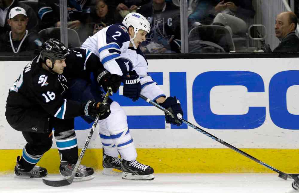 Marcio Jose Sanchez / The Associated Press
Winnipeg Jets' Adam Pardy (2) is defended by San Jose Sharks' Mike Brown during the second period of Thursday's game in San Jose.