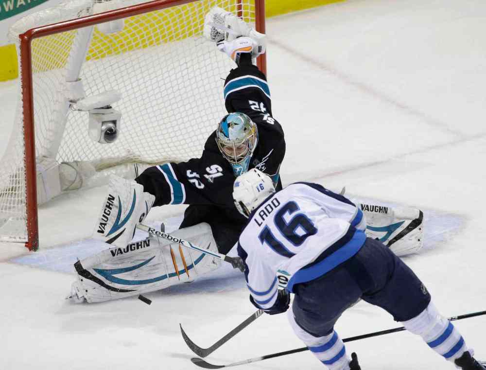 Marcio Jose Sanchez / The Associated Press
San Jose Sharks' goalie Alex Stalock (32) stops a shot by Winnipeg Jets' Andrew Ladd (16) during the first period Thursday's NHL hockey game in San Jose, Calif.