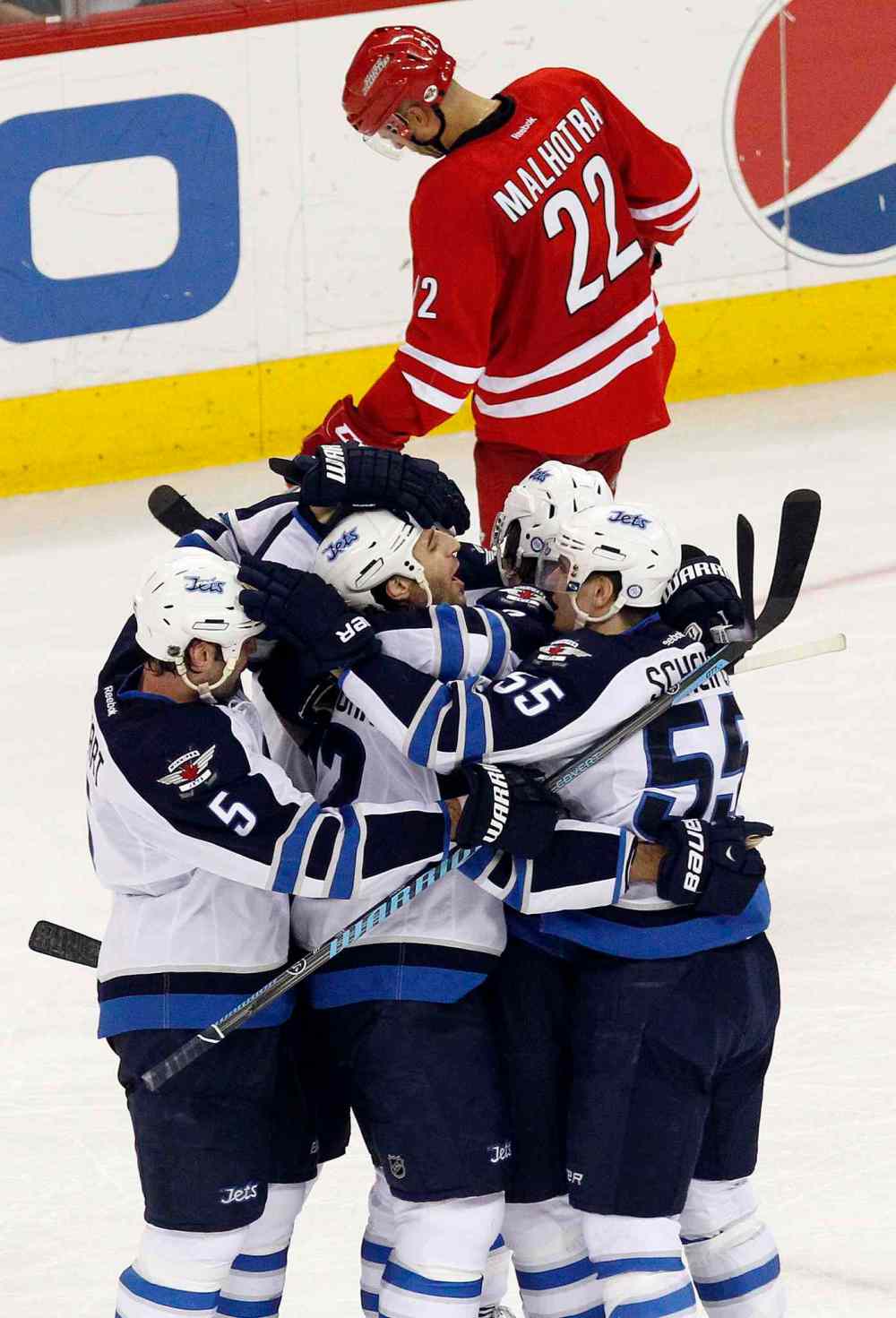 Chris Seward / Raleigh News & Observer/ Tribune Media MCT
Winnipeg Jets' Chris Thorburn (22), centre, celebrates his game-winning goal with teammates Mark Stuart (5) and Mark Scheifele (55) during the third period of Tuesday's game against the Carolina Hurricanes. The Jets beat the Canes 2-1.