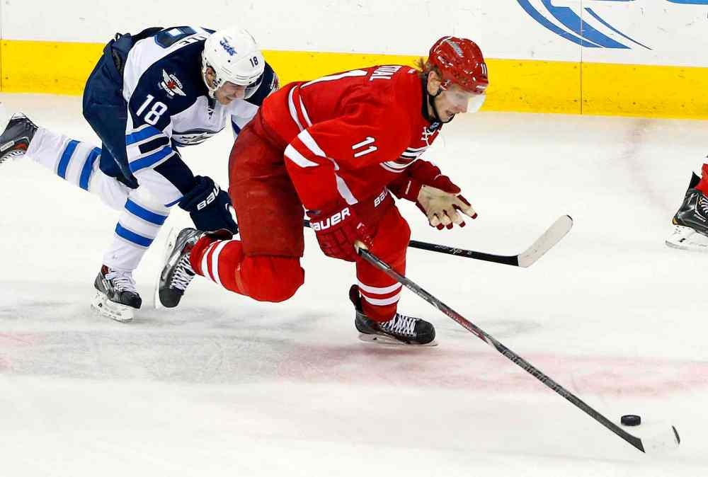 Karl B DeBlaker / The Associated Press
Carolina Hurricanes' Jordan Staal (11) tries to skate away from Winnipeg Jets' Bryan Little (18) during the third period of Tuesday's game.