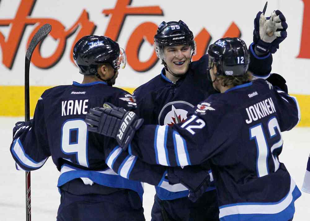 John Woods / Winnipeg Free Press
Winnipeg Jets' Evander Kane (9), Mark Scheifele (55) and Olli Jokinen (12) celebrate Jokinen's goal on Tampa Bay Lightning's goaltender Anders Lindback (39) in the first period of Tuesday's game.