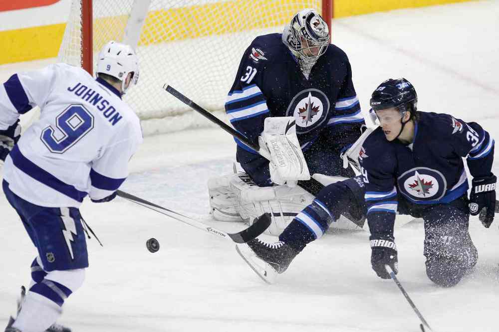 John Woods / Winnipeg Free Press
Winnipeg Jets' Tobias Enstrom (39) blocks the first-period shot by Tampa Bay Lightning's Tyler Johnson (9) in front of Jets' goaltender Ondrej Pavelec (31).
