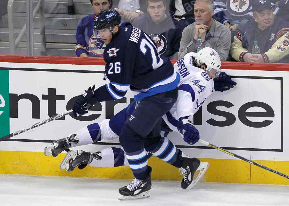 John Woods / Winnipeg Free Press
Winnipeg Jets' Blake Wheeler (26) checks Tampa Bay Lightning's Nate Thompson (44) during first period NHL action in Winnipeg Tuesday.
