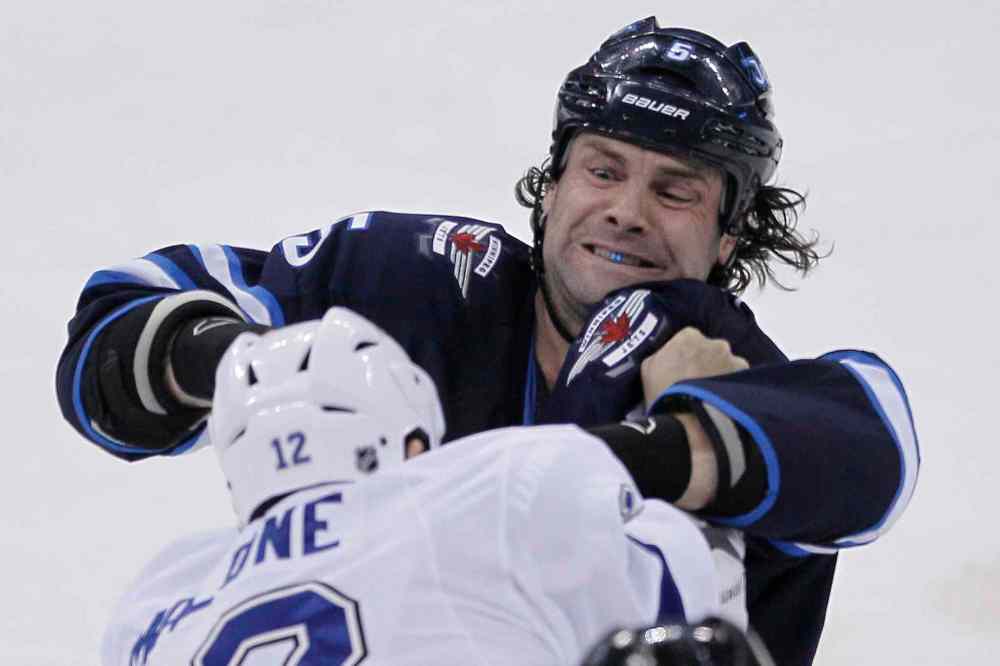 John Woods / Winnipeg Free Press
Winnipeg Jets' Mark Stuart (5) and Tampa Bay Lightning's Ryan Malone (12) fight during the first period Tuesday.