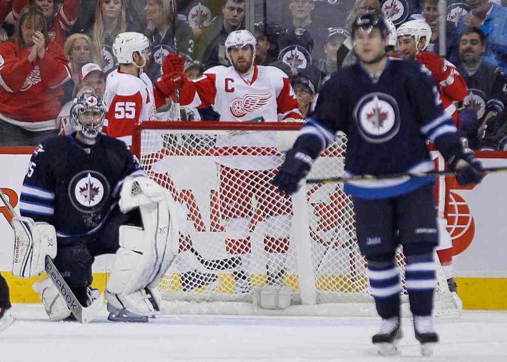 JOHN WOODS / THE CANADIAN PRESS
Detroit Red Wings forwards Niklas Kronwall (55) and Henrik Zetterberg celebrate a goal against the Winnipeg Jets goaltender Al Montoya during the second period.