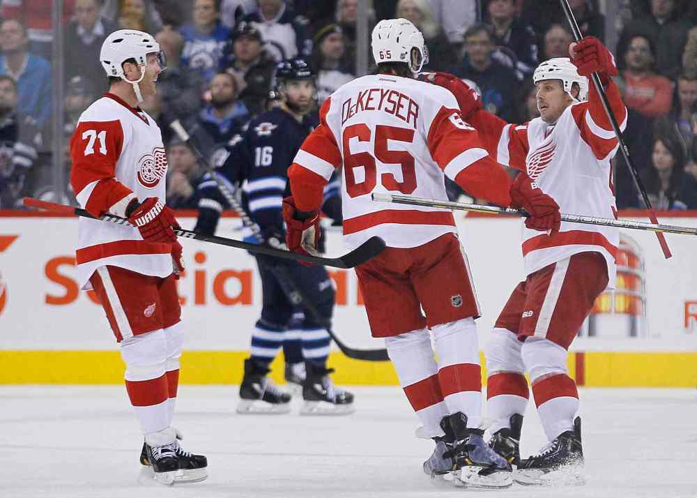JOHN WOODS / THE CANADIAN PRESS
Detroit Red Wings forwards Daniel Cleary (71), Danny DeKeyser (65) and Stephen Weiss celebrate DeKeyser's second-period goal.