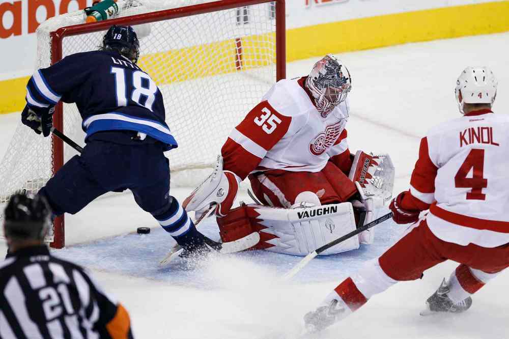 JOHN WOODS / THE CANADIAN PRESS
Winnipeg Jets forward Bryan Little (18) scores on a breakaway against Detroit Red Wings goaltender Jimmy Howard as Wings defenceman Jakub Kindl tries to catch up.