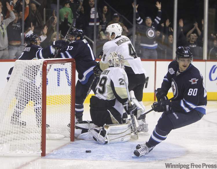 Alexander Burmistrov, Kyle Wellwood and Nik Anotropov of the Winnipeg Jets celebrate after scoring their first goal only eight seconds into the first period against the Pittsburgh Penguins. (Trevor Hagan / Winnipeg Free Press)