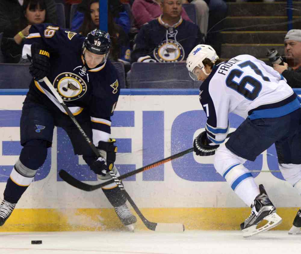 Bill Boyce / The Associated Press
St. Louis Blues' Jay Bouwmeester (19) and Winnipeg Jets' Michael Frolik (67) battle for the puck during the first period of Tuesday's game.