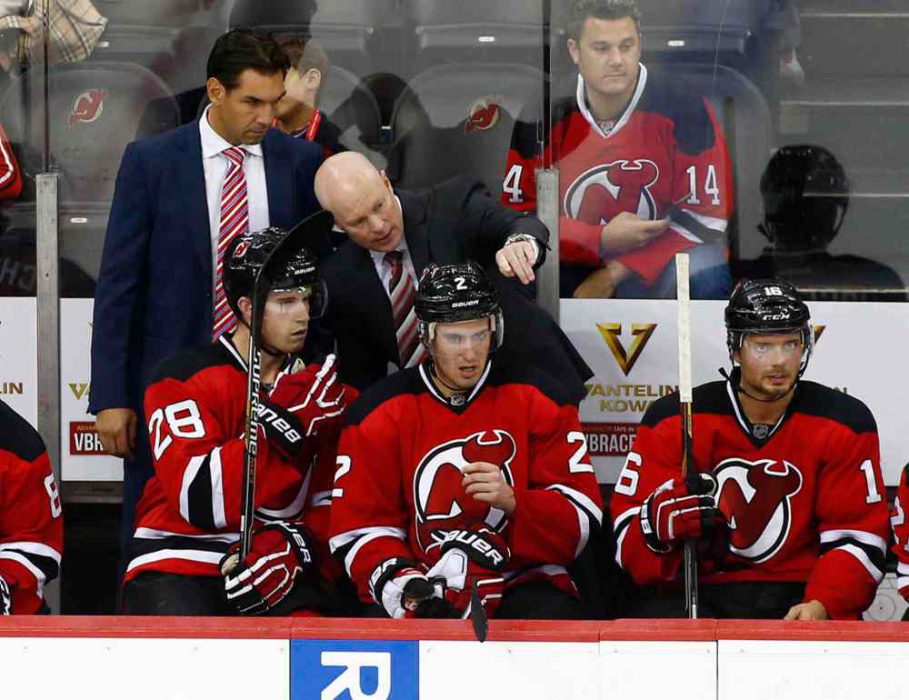 Rich Schultz / The Associated Press
New Jersey Devils head coach John Hynes talks to Damon Severson (28) as John Moore (2) and Jacob Josefson (16), of Sweden, sit during the third period.
