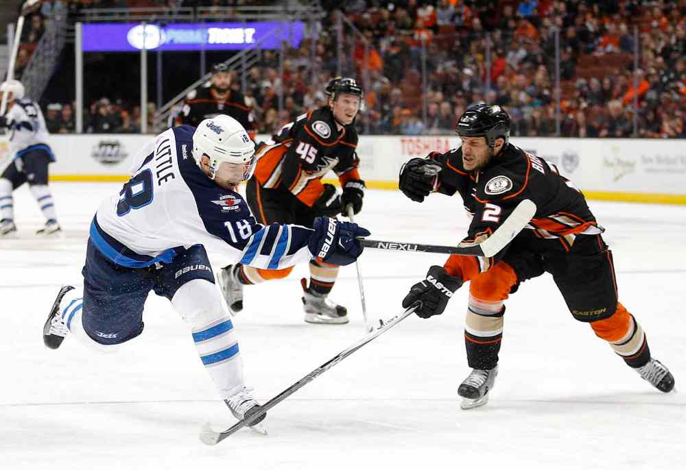 Jae C. Hong / The Associated Press
Winnipeg Jets' Bryan Little, left, shoots under pressure by Anaheim Ducks' Kevin Bieksa during the third period of Sunday's game in Anaheim.