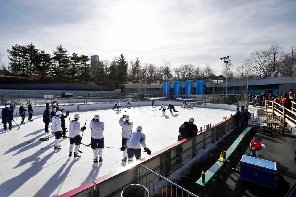 Jason DeCrow / The Associated Press
The Winnipeg Jets run a drill during a practice at Lasker rink in New York's Central Park on Saturday.