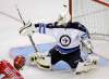 Rick Havner / The Associated Press
Winnipeg Jets goalie David Aebischer (1) blocks a shot as Carolina Hurricanes' Brandon Sutter moves in during the third period of a preseason NHL hockey game in Charlotte, N.C., Sunday. Carolina defeated Winnipeg 4-0.
