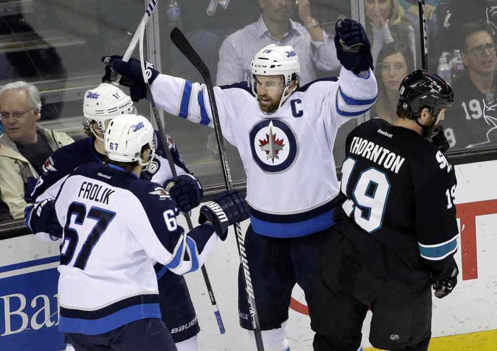 Marcio Jose Sanchez / The Associated Press
Winnipeg Jets' Andrew Ladd, center, celebrates his goal against the San Jose Sharks during the first period Thursday night in San Jose, Calif.