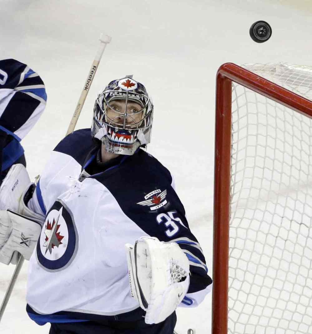 Marcio Jose Sanchez / The Associated Press
Winnipeg Jets goalie Al Montoya deflects a San Jose Sharks shot during the first period.