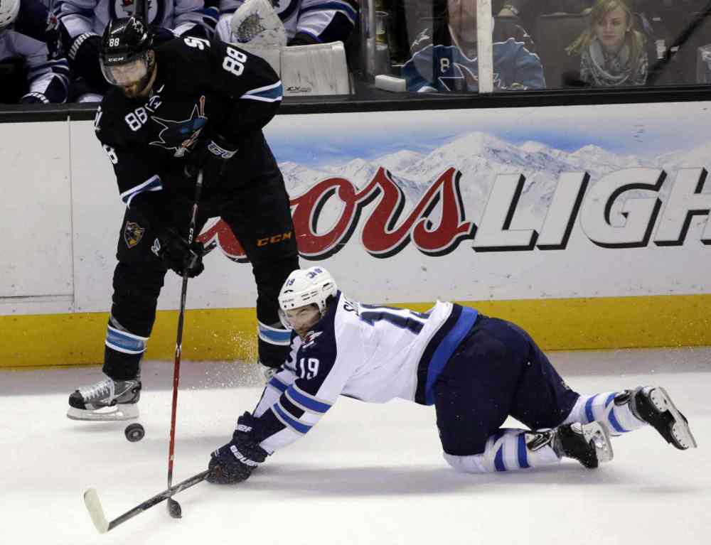 Marcio Jose Sanchez / The Associated Press
San Jose Sharks' Brent Burns (88) passes next to Winnipeg Jets' Jim Slater (19).