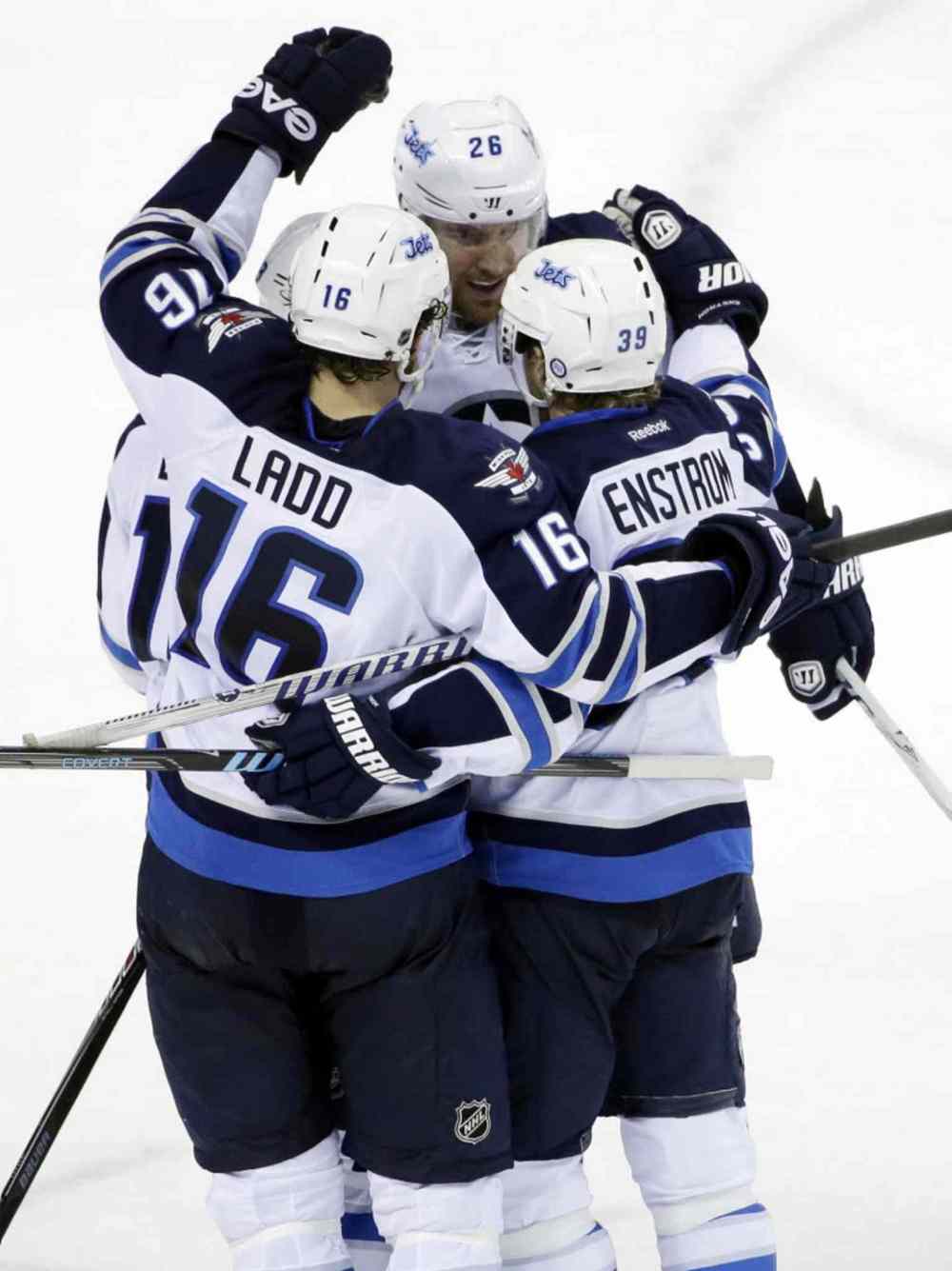 Marcio Jose Sanchez / The Associated Press
Winnipeg Jets' Tobias Enstrom is hugged by teammates after scoring the go-ahead goal against the San Jose Sharks during the third period.